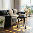 Black Bluetooth speaker side table beside a living-room sofa